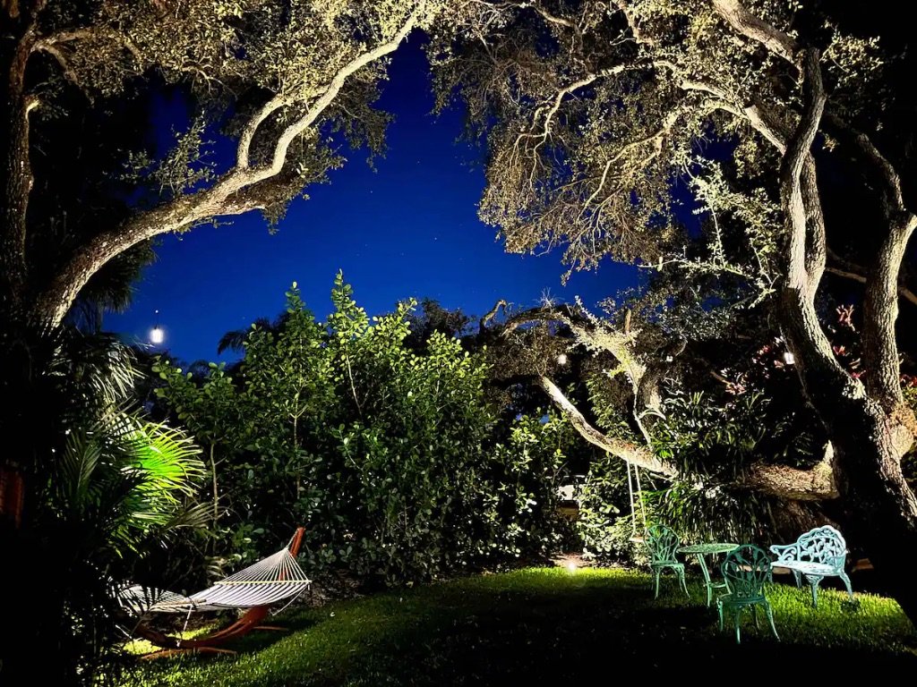 Vero Oaks backyard at night with hammock ambient lighting and oak trees