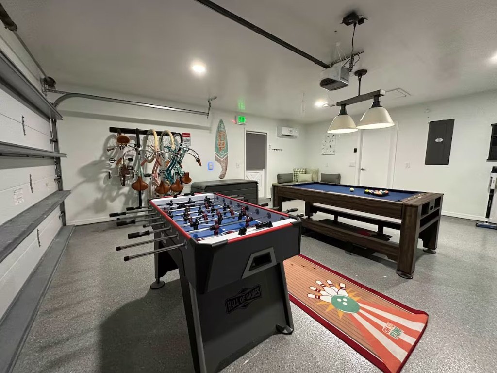 Vero Oaks game room with foosball pool table shuffleboard and lounge seating